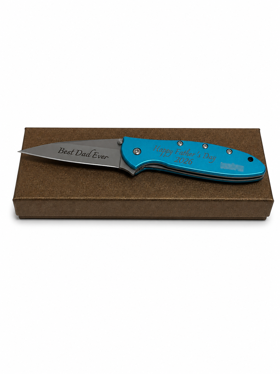 A personalized folding pocket knife with a bright turquoise blue handle and a silver blade, resting on a brown textured gift box. The handle is engraved with 'Happy Father's Day 2025' and 'Best Dad Ever' is engraved on the blade.