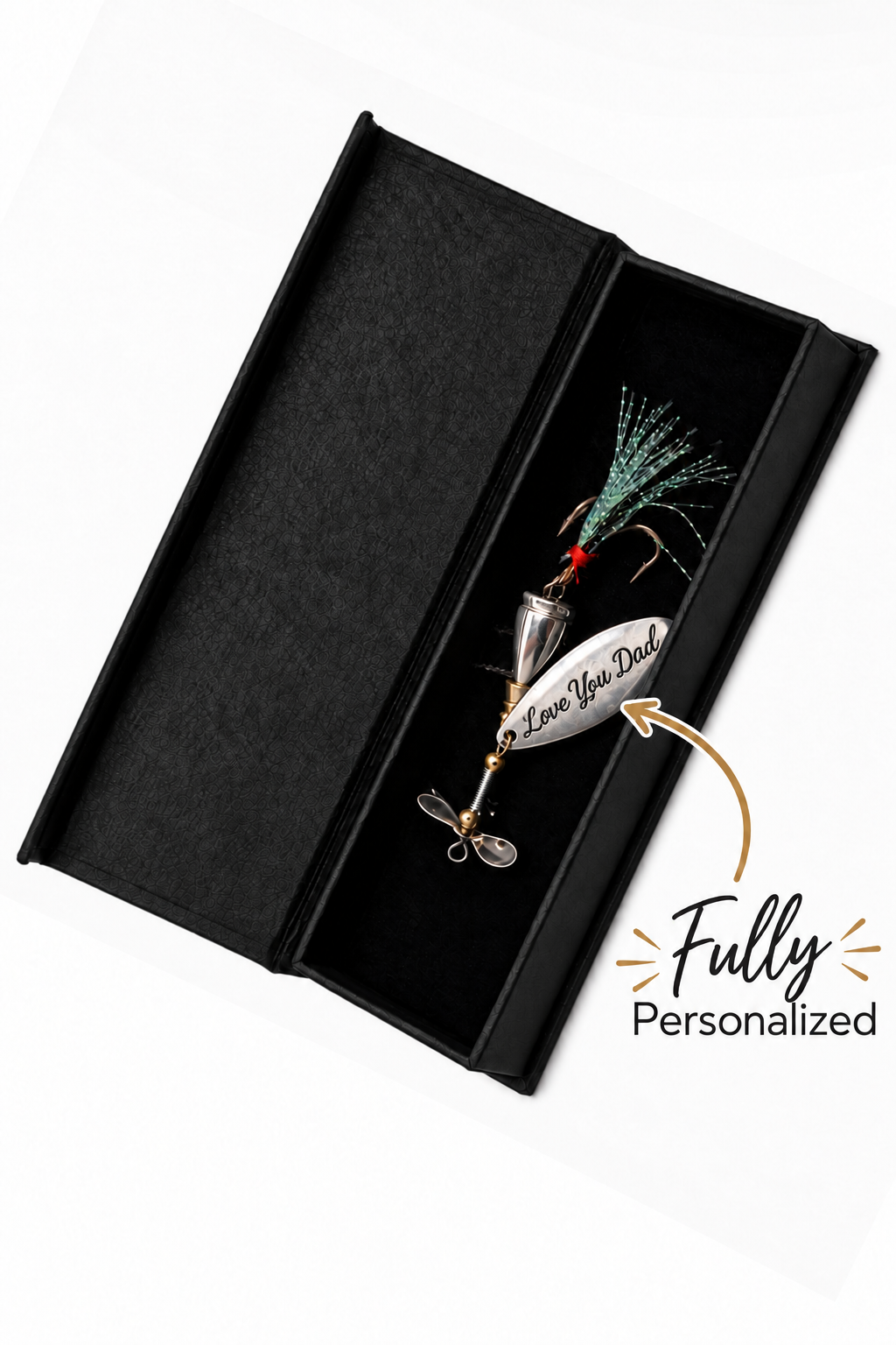 A silver metal fishing lure with a green and black skirt and a white tag reading 'Love Your Dad' inside an open black presentation box, on a white background with a 'Fully Personalized' graphic overlay.